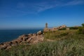 View on the coast of pink granite and the lighthouse of Men Ruz Royalty Free Stock Photo