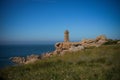 View on the coast of pink granite and the lighthouse of Men Ruz Royalty Free Stock Photo