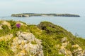 A view from the coastal path at Lydstep, Wales across the bay to Caldey island home to Cistercian Monks Royalty Free Stock Photo