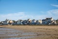 View of coastal street of Grandcamp Maisy, a scenic French coastal town in Normandy, with fishing port, sandy beaches Royalty Free Stock Photo