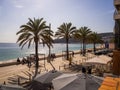View of the coastal town of Sesimbra with palms on the street and beach Royalty Free Stock Photo