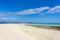 View of coastline of Iranja Island, Nosy Iranja lined with palm trees and boats floating in the sea, Madagascar Royalty Free Stock Photo