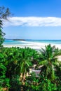 View of coastline of Iranja Island, Nosy Iranja lined with palm trees and boats floating in the sea, Madagascar Royalty Free Stock Photo