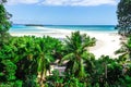 View of coastline of Iranja Island, Nosy Iranja lined with palm trees and boats floating in the sea, Madagascar Royalty Free Stock Photo