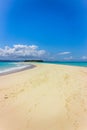 View of coastline of Iranja Island, Nosy Iranja lined with palm trees and boats floating in the sea, Madagascar Royalty Free Stock Photo