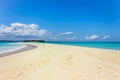 View of coastline of Iranja Island, Nosy Iranja lined with palm trees and boats floating in the sea, Madagascar Royalty Free Stock Photo