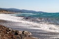 View at the coastline with pebble beach and water waves on the westside of Greek island Rhodes Royalty Free Stock Photo