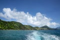 View of the coastline from the sea with the wake of the boat, St Kitts, Caribbean Royalty Free Stock Photo