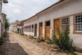 View of cobblestone alley with old colorful houses and blue cloudy sky in Paraty. Royalty Free Stock Photo