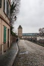 cobblestone street on stoned tower background at little france quarter in Strasbourg by winter