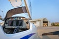 View of the cockpit of a small plane against a hangar. Royalty Free Stock Photo