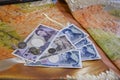 Coins and paper banknotes of Japanese yen on the background of national fabric with embroidery Royalty Free Stock Photo