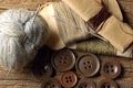 A COLLECTION OF ASSORTED MILITARY REPAIR KIT THREAD AND DARNING YARN AND NEEDLES ON A WOODEN BOARD Royalty Free Stock Photo