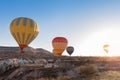 View of colorful hot air balloons flying over the Red valley on sunrise. Goreme, Cappadocia, Turkey Royalty Free Stock Photo