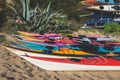 View of colorful kayaking equipment on a sandy beach, process of kayaking by the Ionian sea beach, with canoe kayak boat paddling Royalty Free Stock Photo