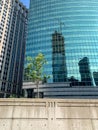 View of colorful skyscraper and concrete wall barrier separating upper Wacker Dr. from the Chicago River, with engravement of III