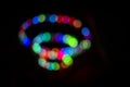 Colorful swirling spiral of bokeh lights at night