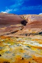 View on colorful valley with yellow sulfur deposits in volcanic barren dry landscape with red mountains background Royalty Free Stock Photo