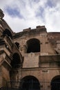 View of The Colosseum, a large amphitheater located in Rome, Italy, seen from a low angle looking up