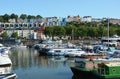 A view of the colourful terraces of houses overlooking the boats moored in Bristol Harbour.
