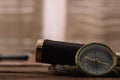 View of compass near telescope and rope cable on wooden table Royalty Free Stock Photo