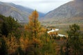 View through the compound to a picturesque autumn valley with a calm river flowing, surrounded by mountain ranges Royalty Free Stock Photo