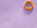 View of the concrete plastered wall of purple color on which decor elements in the form of hexagons hang from which hard shadows f Royalty Free Stock Photo