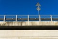 A view of a concrete road railing with road sign