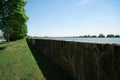 View of a concrete wall in the riverbank under a clear sky background Royalty Free Stock Photo