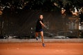 view on confident female tennis player with racket ready to hit a tennis ball. Royalty Free Stock Photo