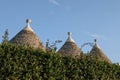 View of the conical dry stone roofs of a group of trulli houses outside Alberobello in Puglia Italy