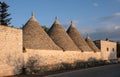 View of the conical dry stone roofs of a group of trulli houses outside Alberobello in Puglia Italy