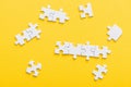 View of connected jigsaw puzzle pieces isolated on yellow