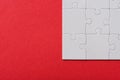 View of connected white jigsaw puzzle pieces isolated on red