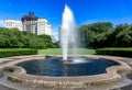 View of Conservatory Garden`s single central fountain jet in front of the symmetrical lawn,