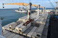 View from container cargo vessel with cranes under loading operation on the aircraft carrier.