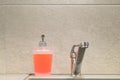 View of a container of liquid soap on a gray kitchen sink, clean house Royalty Free Stock Photo