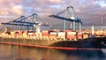 View of a container ship in port undergoing loading for international trade Royalty Free Stock Photo