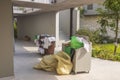 View of containers with dirty bed clothes at hotel`s backyard. Royalty Free Stock Photo