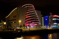 View of Convention Centre over the River Liffey in Dublin, Ireland at night, illuminated with reflections of lights in the water.