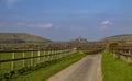 View of Corfe Castle and village from a country lane in the Purbecks, Dorset. Royalty Free Stock Photo