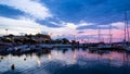 View of Corinth port with boats and piers shot at blue and pink dusk