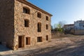 View from the corner of an old renovated stone building with a blue morning sky in the background Royalty Free Stock Photo