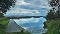 View on Corrib lake trough trees with dramatic blue skies above