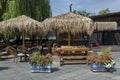 View of cosy nook for summer relaxation below palm sunshade with bar, table, chair and wooden bench, park Borisova gradina Royalty Free Stock Photo