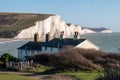 View of cottages overlooking Seven Sisters chalk cliffs at Cuckmere Haven, Seaford, E. Sussex on the south coast of England UK. Royalty Free Stock Photo