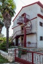 View on country three-storey house with gates of coarse stone an