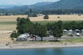 View on countryside and landscape near shoreline with caravan cars and camping van parked in riverside of Columbia river.