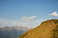 View of a couple watching the sunset on a meadow and the Mountain