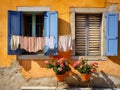 view of the courtyard where the laundry is hung out in front of two windows of the old house Royalty Free Stock Photo